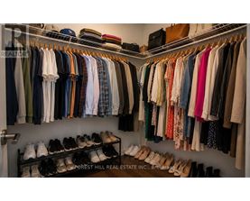 Closet with clothes and shoes.