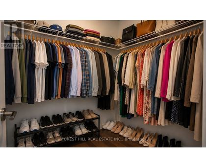 Closet with clothes and shoes.