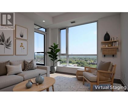 A living room with a couch, a chair, a table, and a view of the outdoors through the windows.