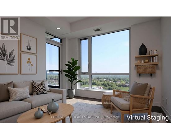 A living room with a couch, a chair, a table, and a view of the outdoors through the windows.