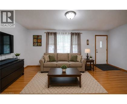 A living room with a couch, a coffee table, and a lamp.