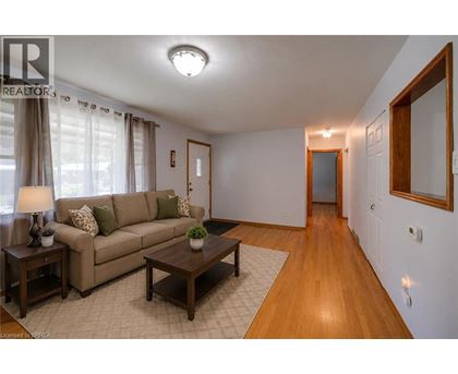 A living room with a brown couch, a coffee table, and a lamp.