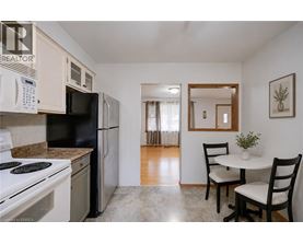 A kitchen with black appliances and white cabinets.