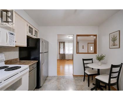 A kitchen with black appliances and white cabinets.