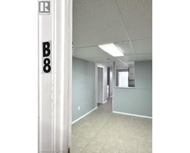 A hallway with a door on the left and a window on the right.