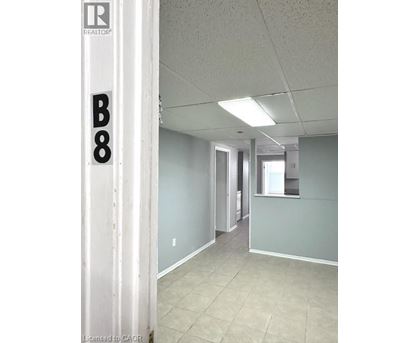 A hallway with a door on the left and a window on the right.
