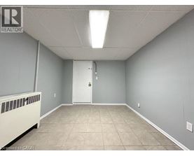 A room with a white door and a radiator on the left side.
