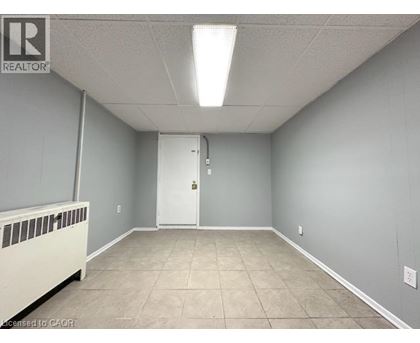 A room with a white door and a radiator on the left side.