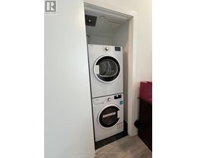 A white washing machine and dryer in a small room.