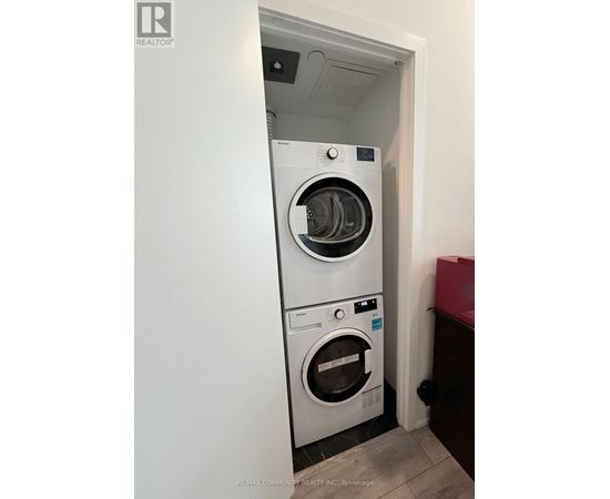 A white washing machine and dryer in a small room.