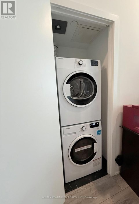 A white washing machine and dryer in a small room.