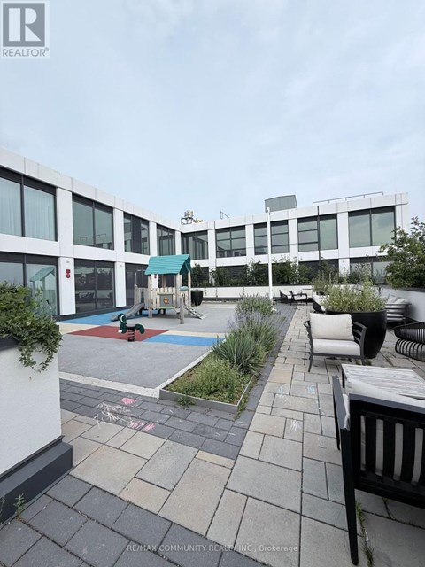 A patio area with a pool table and chairs.