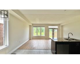 A room with a wooden floor and a sliding glass door.