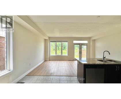 A room with a wooden floor and a sliding glass door.