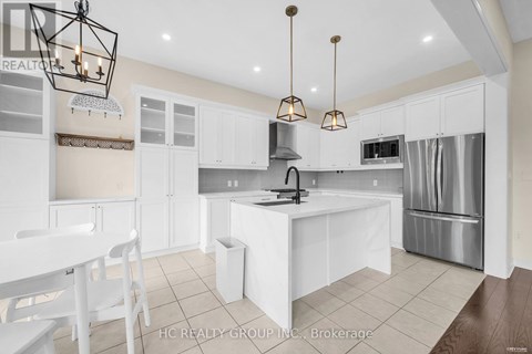 A modern kitchen with white cabinets and a central island.