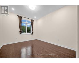 A room with a window and a view of trees outside.