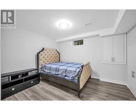A bedroom with a bed, nightstands, and a dresser.