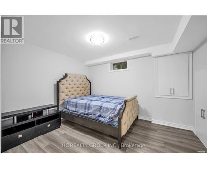 A bedroom with a bed, nightstands, and a dresser.