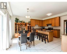 A kitchen with wooden cabinets and a dining table with chairs.