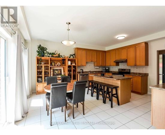 A kitchen with wooden cabinets and a dining table with chairs.