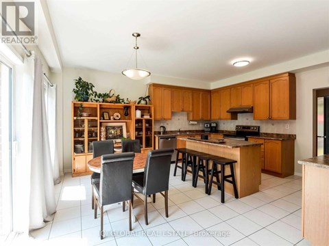 A kitchen with wooden cabinets and a dining table with chairs.