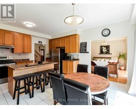 A kitchen with wooden cabinets and a wooden island with bar stools.