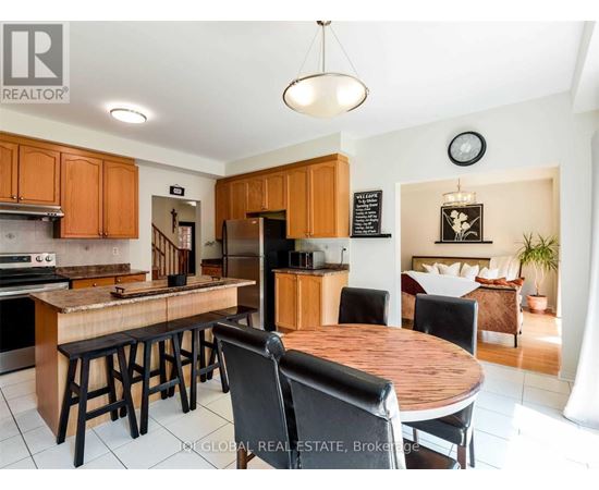 A kitchen with wooden cabinets and a wooden island with bar stools.