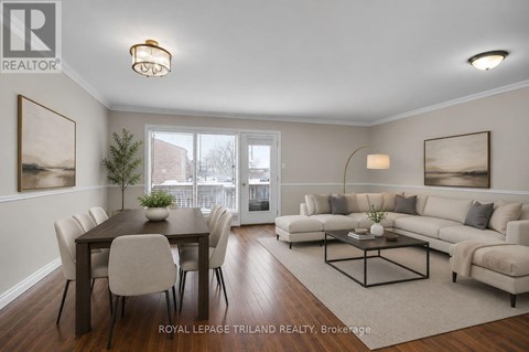 A well-lit living room with a dining table and a couch.