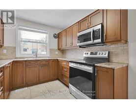 A kitchen with wooden cabinets and a black stove top oven.