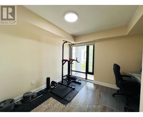 A room with a gym setup including a squat rack, weights, and a bench.
