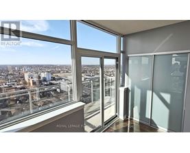 A room with a view of the cityscape from a large window.