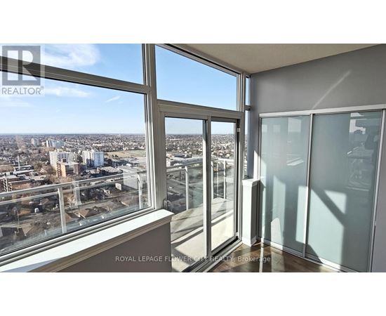A room with a view of the cityscape from a large window.