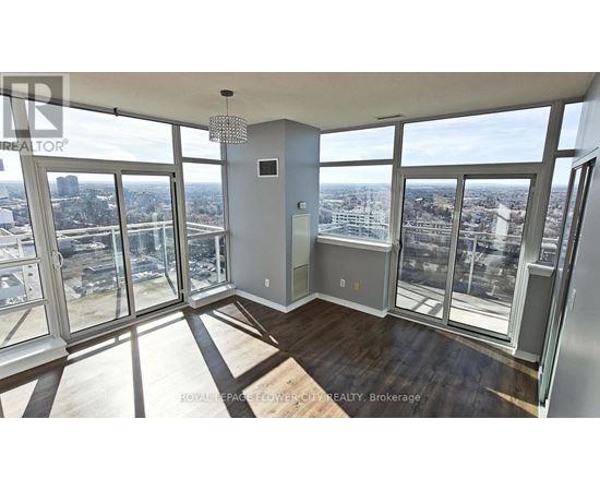 A large, empty room with floor-to-ceiling windows overlooking a cityscape.
