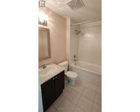 A white toilet sits next to a sink in a bathroom.