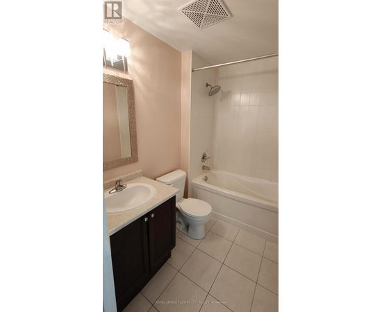 A white toilet sits next to a sink in a bathroom.