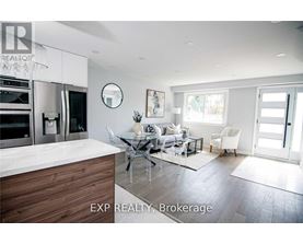 A modern kitchen with a dining table and chairs.