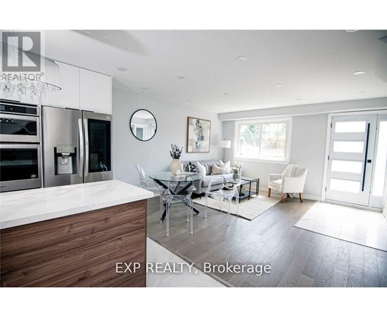 A modern kitchen with a dining table and chairs.