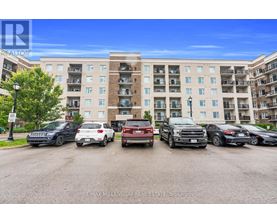 A parking lot with cars and a building in the background.