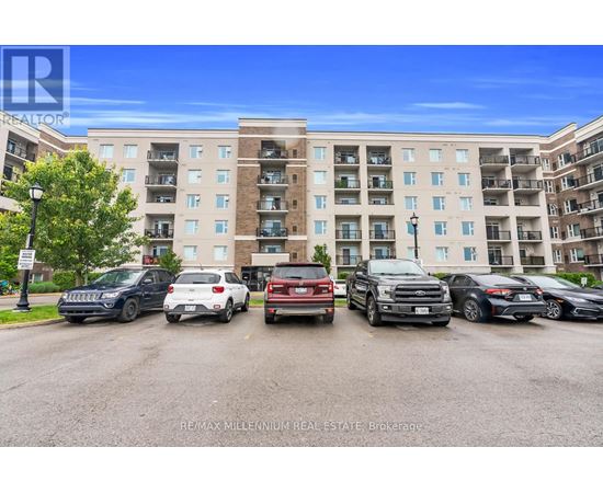 A parking lot with cars and a building in the background.