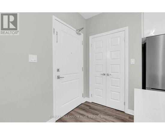 A white door is on the left and a white door with a panel design is on the right.