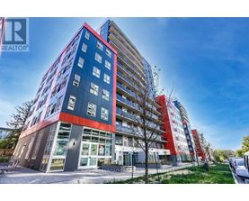 A modern multi-story building with a red and blue facade.
