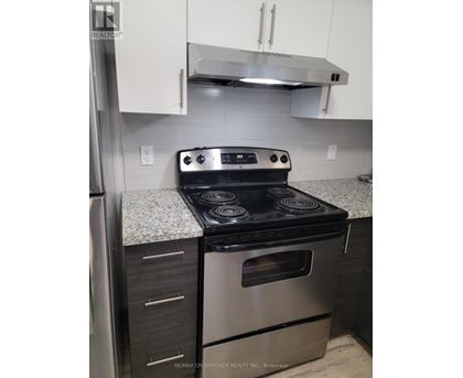 A stainless steel oven with a black top is in a kitchen.