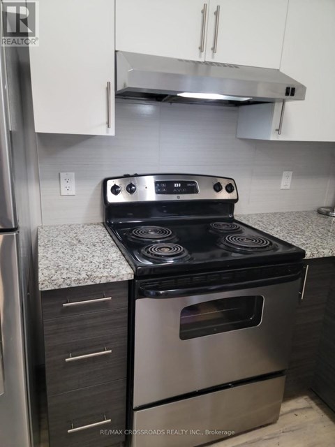 A stainless steel oven with a black top is in a kitchen.