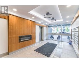A modern interior space with a fireplace and a black rug on the floor.