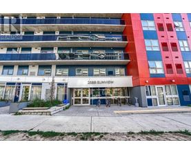 The image shows a multi-story building with a blue and red facade and a sign that reads "2355 Sunview".
