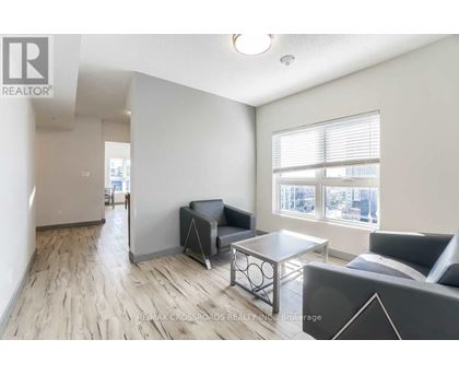 A living room with a couch, chair, and coffee table.