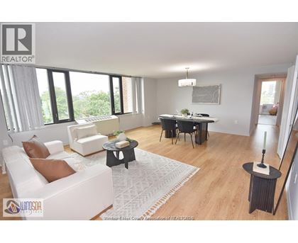 A living room with a white sofa and a black coffee table.