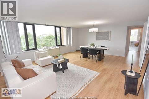 A living room with a white sofa and a black coffee table.
