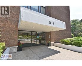 The entrance to a building with a sign that reads "REALTOR" and the number 2144.