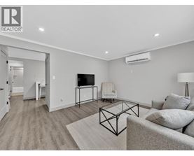 A living room with a grey couch and a black metal coffee table.